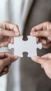Collaborative hands fitting puzzle piece together, symbolizing teamwork and unity Royalty Free Stock Photo