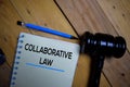 Collaborative Law write on a book isolated on wooden background. Selective focus on text Collaborative Law Royalty Free Stock Photo
