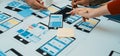 Collaborative Mobile App Design Process with Hands Working on Wireframes and Prototypes at a Table with Tools, Paper Royalty Free Stock Photo