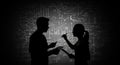 Collaborative Problem Solving Silhouettes Two silhouettes of students collaborate on a problem set against a backdrop of