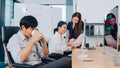 Collaborative process group of multicultural business people in smart casual wear communicating and using technology while working Royalty Free Stock Photo