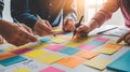 Collaborative team brainstorming and planning session using colorful sticky notes and pens Royalty Free Stock Photo