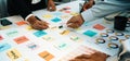 Collaborative Team Brainstorming Session with Sticky Notes and Charts on Table in Modern Office Environment SACTR Royalty Free Stock Photo