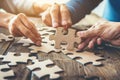 Collaborative Team Building Activity with Hands Connecting Puzzle Pieces Royalty Free Stock Photo