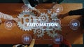 Collaborative Team Meeting on Automation Process with Gears and Data Graphics on Wooden Table for Business Strategy and Royalty Free Stock Photo