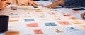 Collaborative Teamwork with Colorful Sticky Notes on White Table for Brainstorming Creative Ideas in Modern Office SACTR Royalty Free Stock Photo