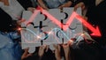 Collaborative Teamwork on Puzzle Pieces with Graphs and Decline Arrow, Symbolizing Strategy and Problem Solving in Royalty Free Stock Photo
