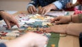 Collaborative Teamwork Solving a Jigsaw Puzzle Royalty Free Stock Photo
