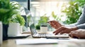 The collaborative workspace featuring hands, laptop, and coffee cup surrounded by plants. AI generated image Royalty Free Stock Photo