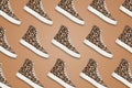 Collage of classic old school sneakers with leopard pattern on brown background Royalty Free Stock Photo