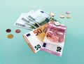 Collage of coins and euro currency banknotes on a blue background Royalty Free Stock Photo