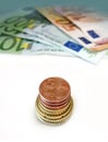 Collage of coins and euro currency banknotes on a white background Royalty Free Stock Photo