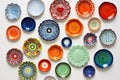 a collage of colorful ceramic plates mounted on a white wall