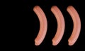 Collage of five boiled sausages, on a black background in isolation