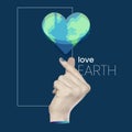 Collage for holiday Earth Day. A female hand holds a glitch planet in the shape of a heart. Text Love the Earth. K-Heart