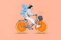 Collage image of excited positive girl black white colors drive bike orange slices instead wheels drawing big hands back