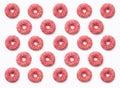 Collage of pink donuts in glaze on a white background. Lots of d