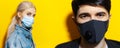 Collage portrait of girl and guy, wearing medical respiratory face mask against coronavirus. Studio background of yellow color.