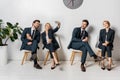 collage of smiling young business people with smartphone and paper cups waiting on chairs Royalty Free Stock Photo