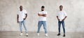 Collage of three different men full body against textured gray wall, dressed in jeans and white T-shirts. Serious guys Royalty Free Stock Photo