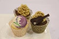 Various cupcakes: vanilla, chocolate, in decorative cups Royalty Free Stock Photo