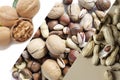Collage of vertical pictures of different types of nuts. Peanuts, almonds, pecans, hazelnuts, walnuts and other nuts, Royalty Free Stock Photo