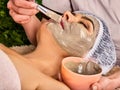 Collagen facial mask skin treatment. Elderly woman 50-60 years old.