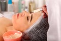 Collagen face mask. Facial skin treatment. Woman receiving cosmetic procedure.