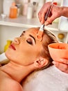 Collagen face mask. Facial skin treatment. Woman receiving cosmetic procedure.