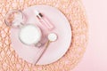 Collagen powder and serum bottle on pink background