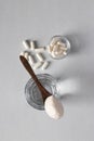 Collagen powder in spoon on glass of water, collagen capsules on light background, healthy and antiage concept. Top view Royalty Free Stock Photo