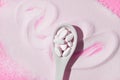 Collagen spoon on a pink background. Top view