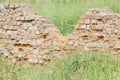 collapsed brick wall among green grass Royalty Free Stock Photo