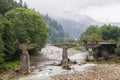 Collapsed bridge standing on a mountain river Royalty Free Stock Photo