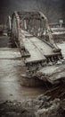 Collapsed bridge, twisted metal, murky river, abandoned, damaged structure, disaster scene Royalty Free Stock Photo
