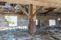 Collapsed roof of the total damaged domestic house indoor from natural disaster or catastrophe with peeled paint and plaster from Royalty Free Stock Photo