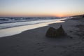 Collapsed sand castle at Matalacanas beach during the magnificent sunrise Royalty Free Stock Photo