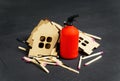 Collapsed toy house, matches and fire extinguisher Royalty Free Stock Photo