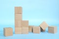 Collapsed wooden building blocks in blue background. Weak foundation and built Conceptual. Royalty Free Stock Photo