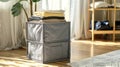 A collapsible fabric storage cube ideal for storing seasonal clothing or household items. .