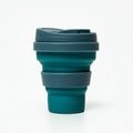 Collapsible silicone cup in teal and gray tones. It features a ridged, stackable design Royalty Free Stock Photo