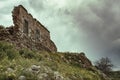 Collapsing damaged brick wall. Abandoned deserted house against cloudy sky Royalty Free Stock Photo