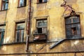 Collapsing facade of an old urban abandoned house with cracks and broken old windows Royalty Free Stock Photo