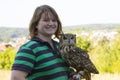 Collared Scops Owl sitting on the hand of animal keeper Royalty Free Stock Photo