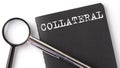 Collateral- business concept, magnifier with white text message on black notebook