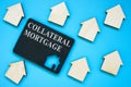 Collateral Mortgage sign on the plate and small houses.