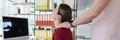 Colleague does neck massage to woman in company office