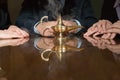 Colleagues around a smoking genie lamp Royalty Free Stock Photo