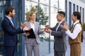 Colleagues business team applauding and greeting colleagues women boss, satisfied people support boss outside office Royalty Free Stock Photo