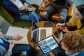 Colleagues and clients talking strategy with laptop and tablet.Top view.Group of multiethnic people having business team Royalty Free Stock Photo